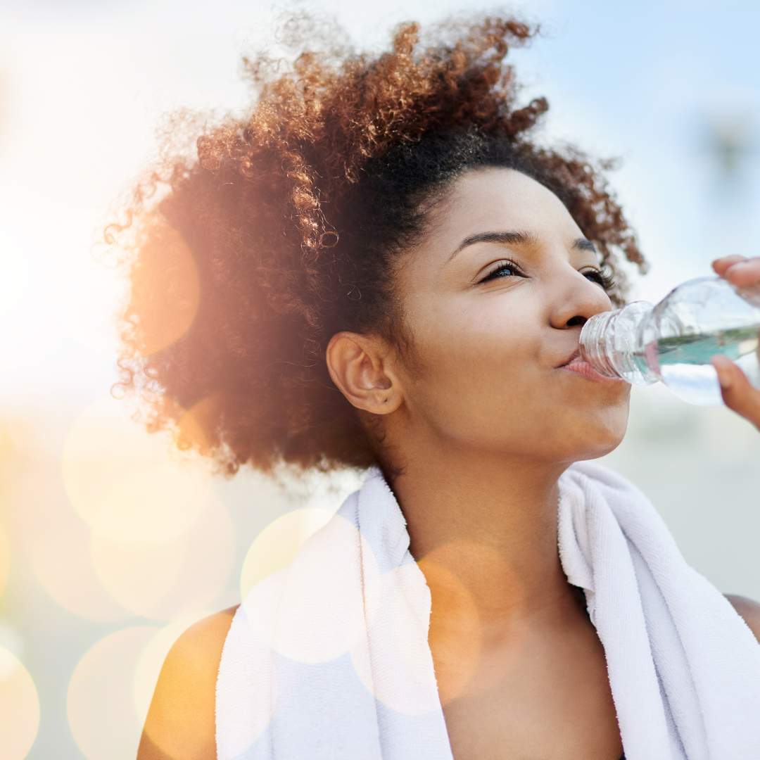 A person drinking water from a bottle.